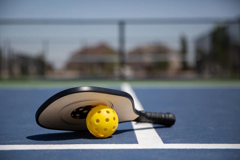 Pickleball Paddle and Ball laying on the floor - Pickleball E-Referee
